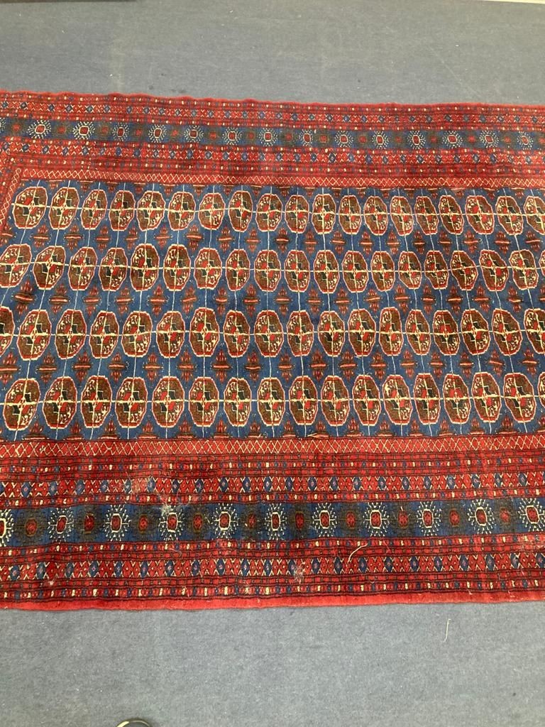 A Bokhara blue ground carpet. 240x150.